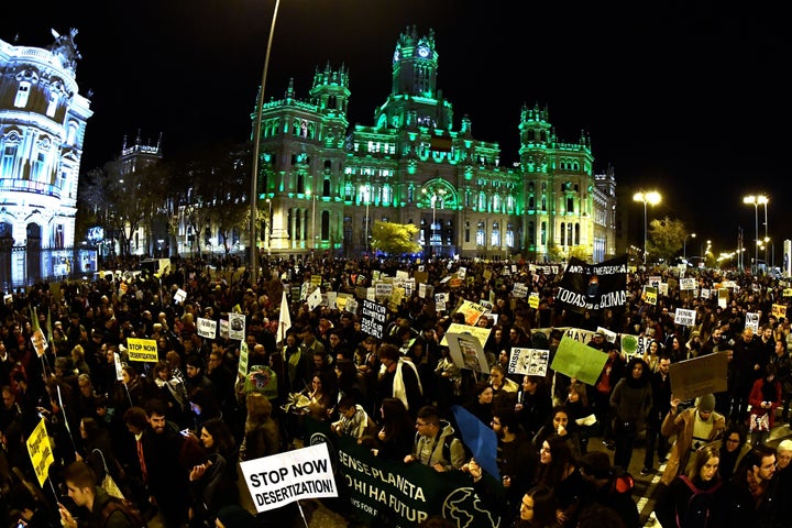 Demonstrators walk past the city hall on Cibeles Square during a mass climate march to demand urgent action on the climate crisis from world leaders attending the COP25 summit in Madrid on Friday.