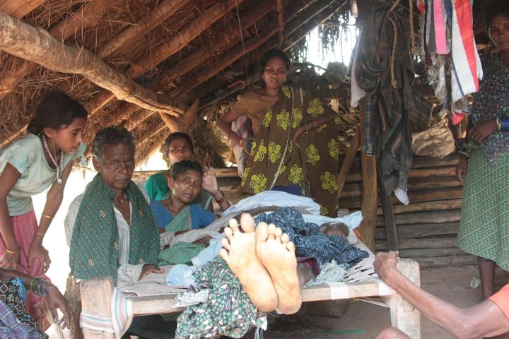 The family of a villager killed by Indian security forces sit by his corpse. Seventeen villagers were killed by Indian security forces in June 2012 in Chhattisgarh.