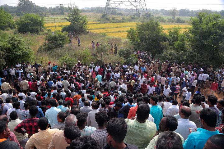 People gather near the site where four men suspected of raping and killing a woman were killed in Shadnagar some 50 kilometers from Hyderabad, Friday, Dec. 6, 2019.