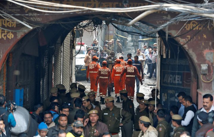 Members of India's National Disaster Response Force (NDRF) head towards the site of the fire. 