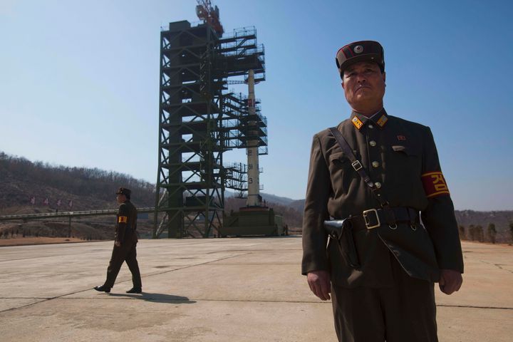 In this file photo, North Korean soldiers stand in front of the country's Unha-3 rocket at Sohae Satellite Station in Tongchang-ri, North Korea on Sunday April 8, 2012. 