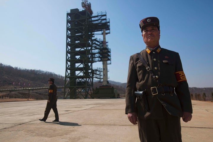 In this file photo, North Korean soldiers stand in front of the country's Unha-3 rocket at Sohae Satellite Station in Tongcha