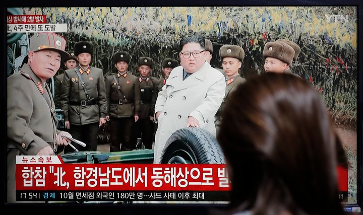 A woman watches a news program reporting North Korea's firing unidentified projectiles with a file image of North Korean leader Kim Jong Un, in Seoul, South Korea, Thursday, Nov. 28, 2019.