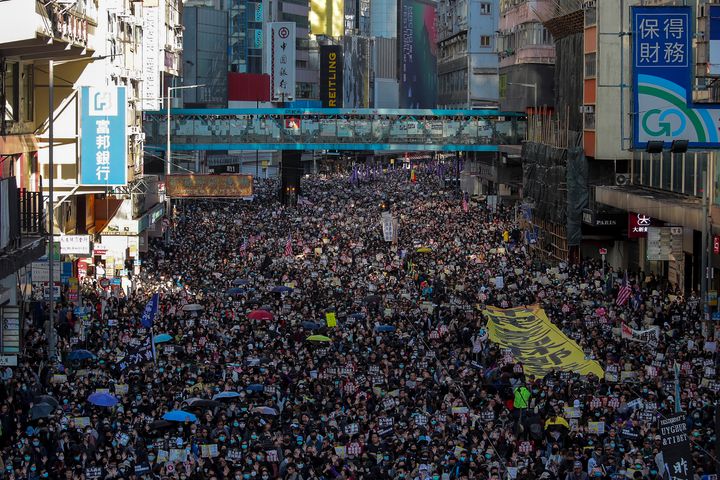 Pro-democracy protesters march on a street during a protest in Hong Kong, Sunday, Dec. 8, 2019. (AP Photo/Kin Cheung)