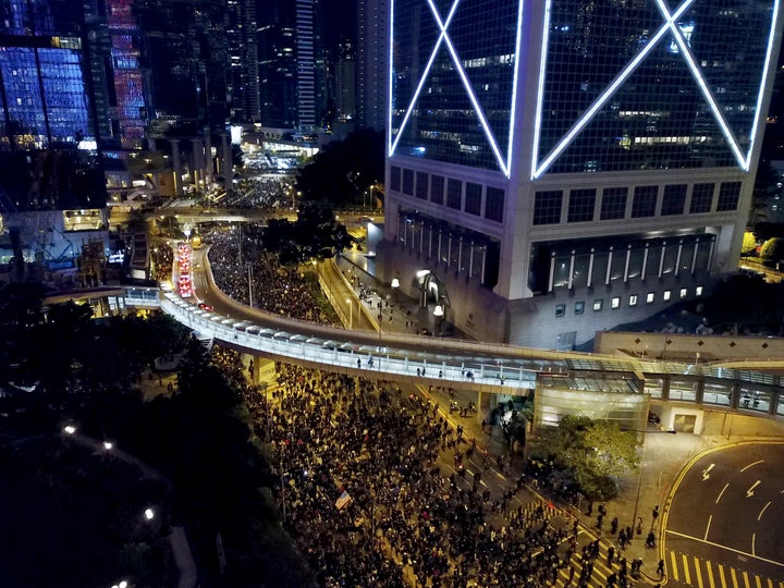 Pro-democracy protesters march into the night in Hong Kong, Sunday, Dec. 8, 2019. (AP Photo/Dake Kang)