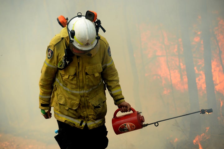 A NSW Rural Firefighter establishes a backburn during bushfires in Mangrove Mountain, New South Wales, Australia, December 8, 2019. AAP Image/Jeremy Piper/via REUTERS