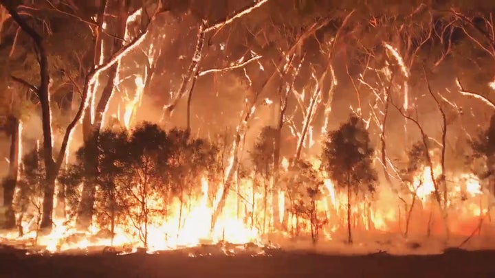 A fire blazes across bush in Newnes Plateau, New South Wales, Australia.