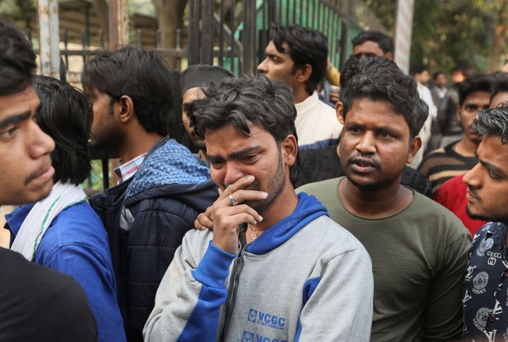 Mohammad Zakir, center, who lost his brother in a fire cries as he waits for the body outside a mortuary in New Delhi, Dec. 8, 2019. 