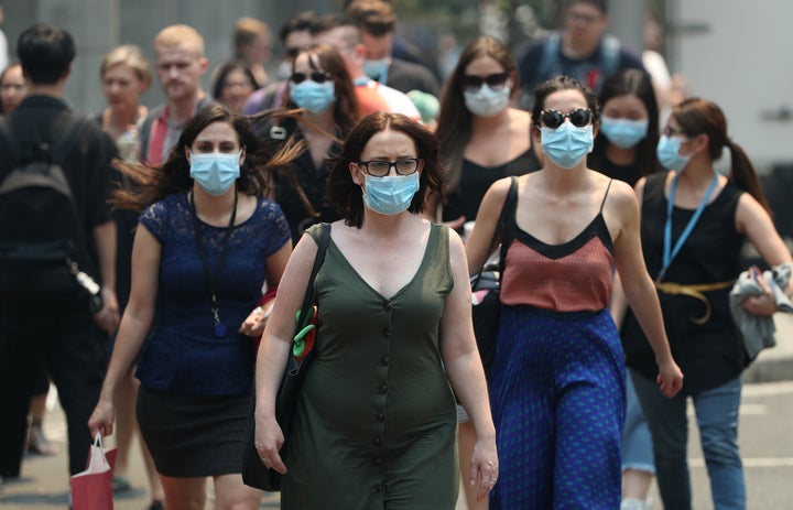 People are seen wearing face masks to protect from smoke haze in Sydney.