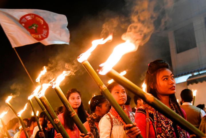 Activists of All Assam Students Union (AASU) take part in a torch light procession to protest against the government's Citizenship Amendment Bill, in Guwahati on December 8, 2019.