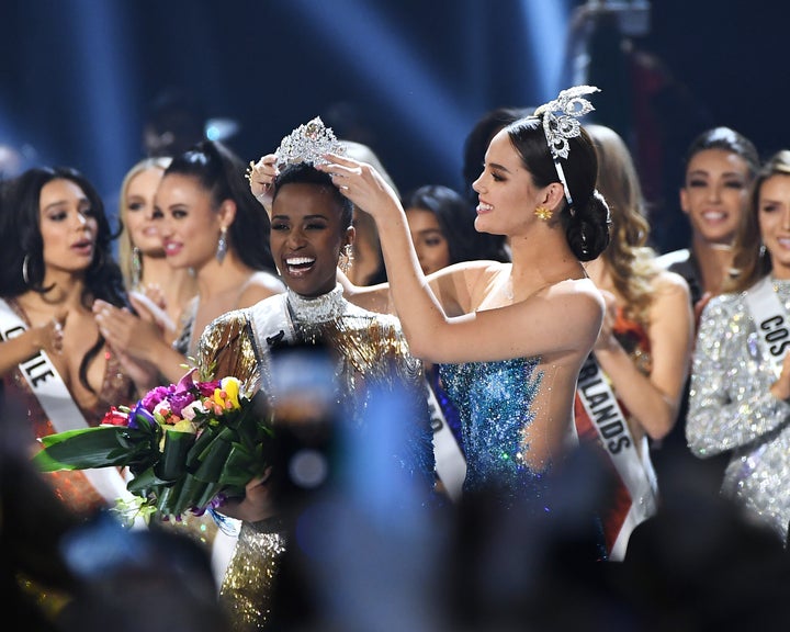 Miss Universe 2019 Zozibini Tunzi, of South Africa, is crowned onstage by Miss Universe 2018 Catriona Gray at the 2019 Miss Universe Pageant at Tyler Perry Studios.