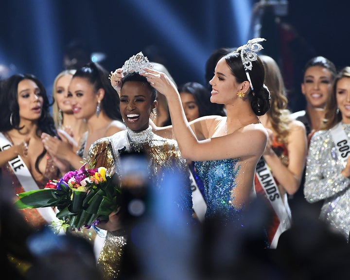 Miss Universe 2019 Zozibini Tunzi, of South Africa, is crowned onstage by Miss Universe 2018 Catriona Gray at the 2019 Miss Universe Pageant at Tyler Perry Studios. 