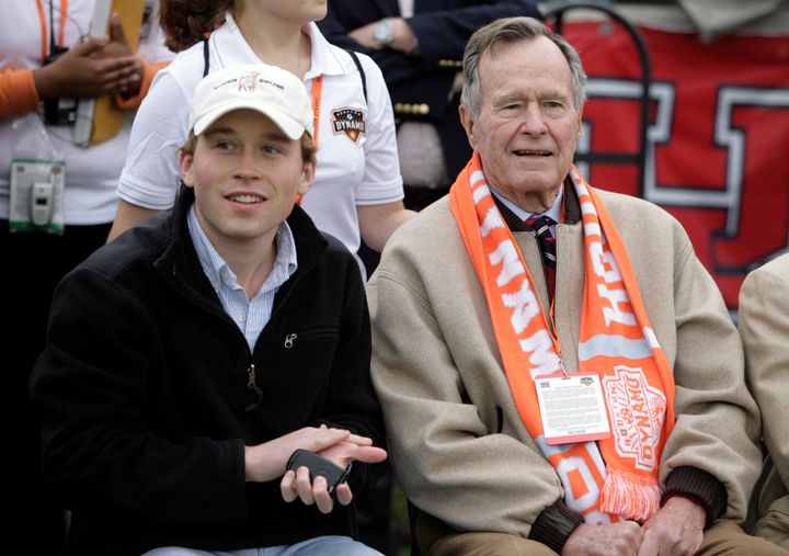 In this file photo, former President George H.W. Bush (right) and grandson Pierce Bush are seen sitting on the sidelines before the Houston Dynamos game against the Los Angeles Galaxy in Houston in April 2007.
