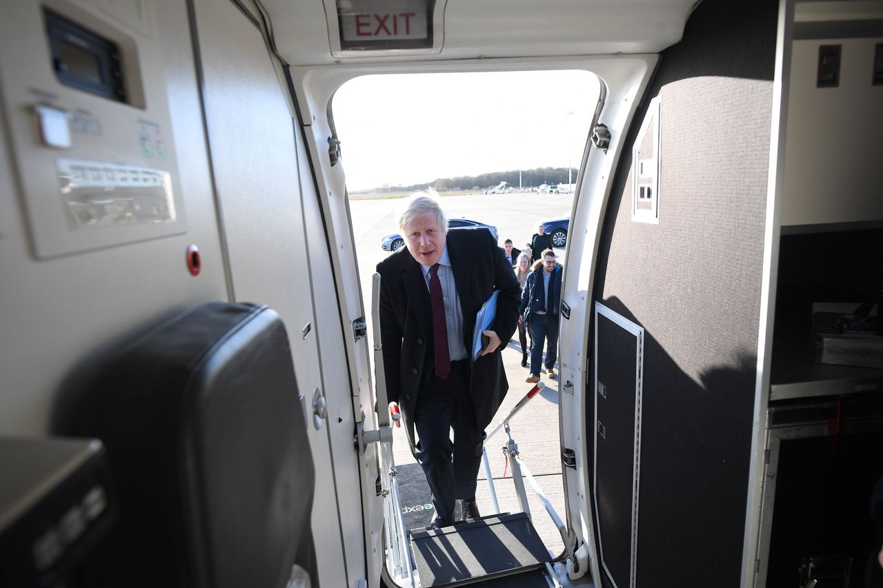 Boris Johnson boards his plane at Robin Hood Airport in Doncaster to fly to Teesside