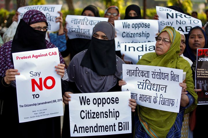 Demonstrators display placards during a protest against the Citizenship Amendment Bill in Ahmedabad, India, December 9, 2019.