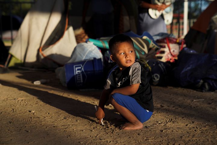 Elias, 2, a Honduran asylum-seeking child, plays near the tent where he lives after being relocated from the plaza near the Gateway International Bridge in Matamoros, Mexico, on Dec. 7, 2019.
