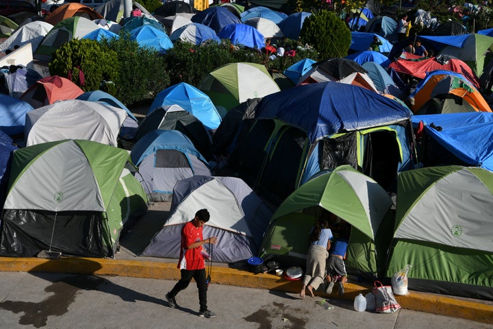 Migrants, most of them asylum-seekers sent back to Mexico from the U.S. under the "Remain in Mexico" program, occupy a makeshift encampment in Matamoros, Mexico, on Oc. 28, 2019.