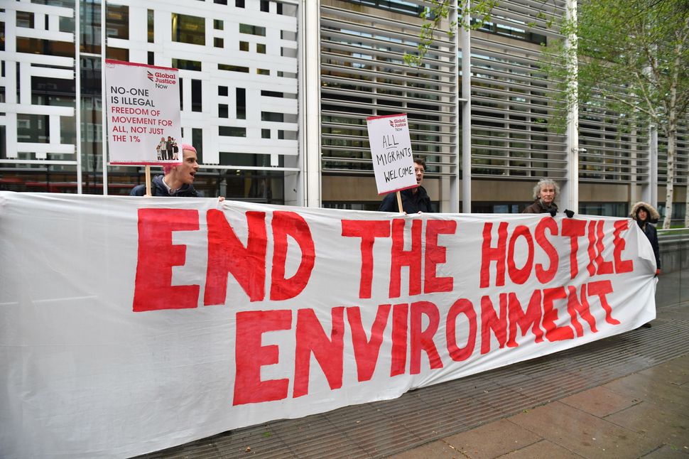 Demonstrators protest against the hostile environment immigration policy outside the Home Office in Westminster, London. Ambe