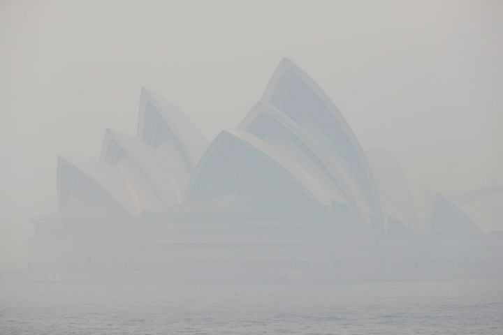 Thick smoke from wildfires shroud the Opera House in Sydney, Australia, Tuesday, Dec. 10, 2019. Hot dry conditions have brought an early start to the fire season. (AP Photo/Rick Rycroft)