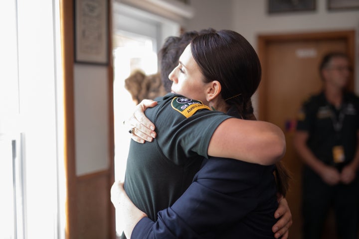 New Zealand Prime Minister Jacinda Ardern hugs a first responder who helped those injured in the White Island volcano eruption the day before, at the Whakatane Fire Station in Whakatane on Tuesday.