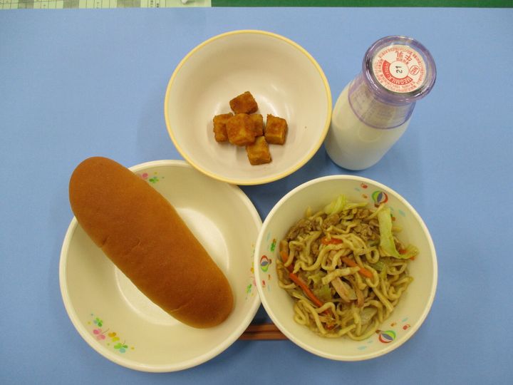 2019年の名古屋市の小学校の給食の例。メニューは小型ロールパン、牛乳、カレー焼きそば、揚げどうふ