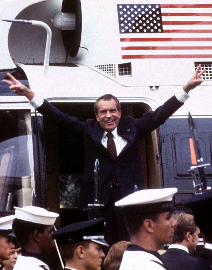 Following his resignation, U.S. President Richard M. Nixon flashes the V-for-victory sign as he boards his Marine One helicop