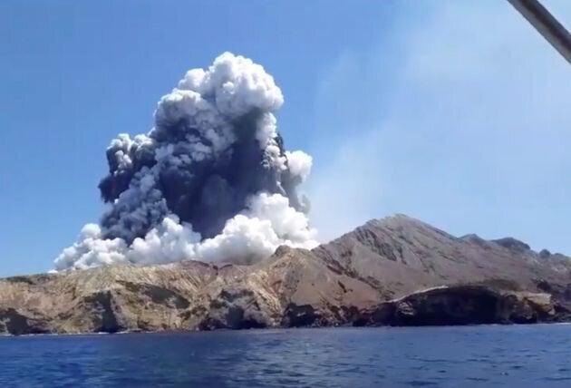 Smoke from the volcanic eruption of Whakaari, also known as White Island, is pictured from a boat, New Zealand December 9, 2019 in this picture grab obtained from a social media video. 