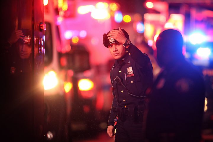 A police officer works the scene of a shooting that left multiple people dead 