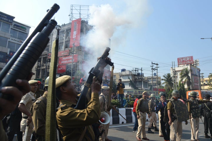 Police personnel fire tear gas to disperse the students protesting against the government's Citizenship Amendment Bill (CAB), in Guwahati on December 11, 2019. 