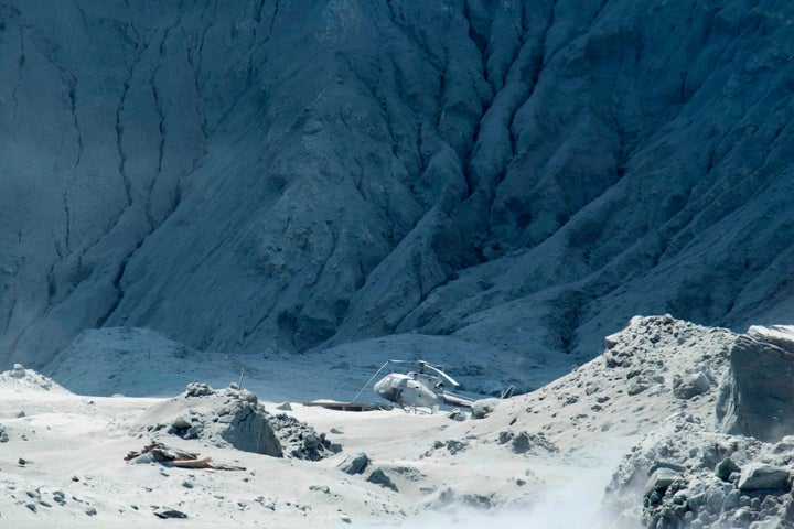 A damaged helicopter is seen following the volcanic eruption. Unstable conditions continued to hamper rescue workers from searching for people missing and feared dead.