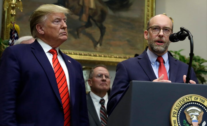 President Donald Trump listens on Oct. 9 as the acting director of the Office of Management and Budget, Russ Vought, speaks about "transparency in federal guidance and enforcement" at the White House.