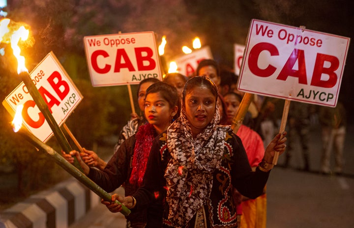 Indians participate in a torch light procession to protest against the Citizenship Amendment Bill (CAB) in Gauhati, northeastern Assam state, India.