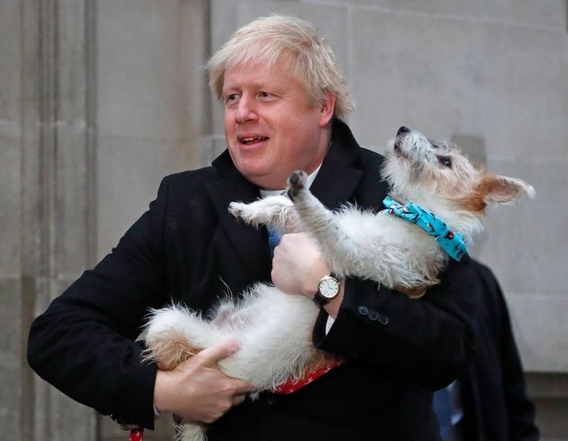 The prime minister holding his dog Delyn on election day 