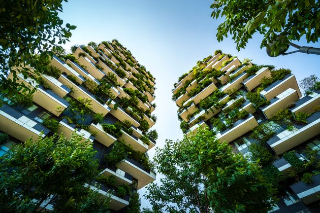 Milan, Italy, High-rise house with trees, shrubs and hedges in the city of