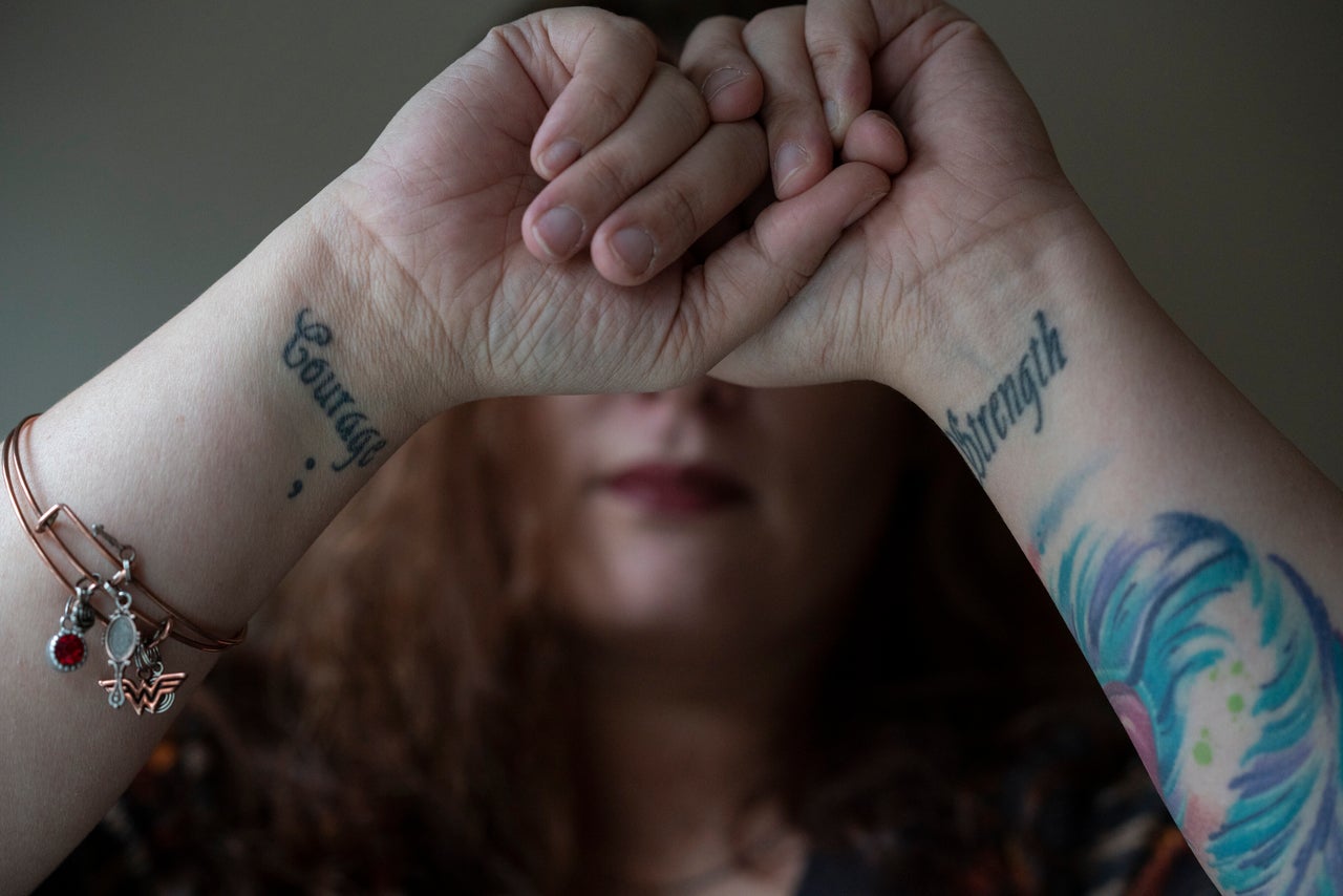  Before leaving her ex-husband she got tattoos on her wrists with the words "Strength" and "Courage" to remind herself, she said, that she had both inside of her. 