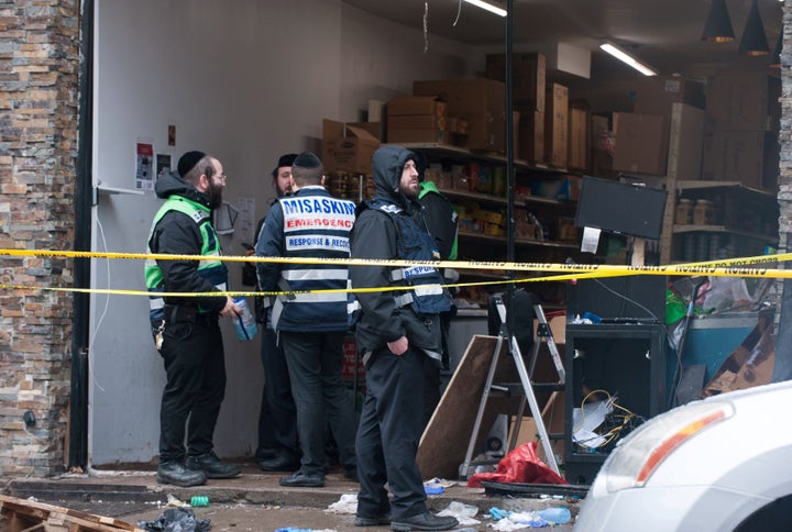 Emergency personnel and investigators work at the scene the day after an hours-long gun battle with two men around a kosher market in Jersey City, New Jersey, U.S., December 11, 2019. REUTERS/Lloyd Mitchell