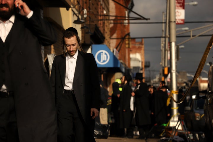 Members of the Jewish community gather around the JC Kosher Supermarket on Wednesday.