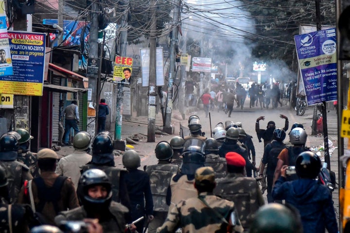 Demonstrators shout slogans as police fire tear gas during a protest against the government's Citizenship Amendment Bill (CAB) in Guwahati on December 12, 2019.