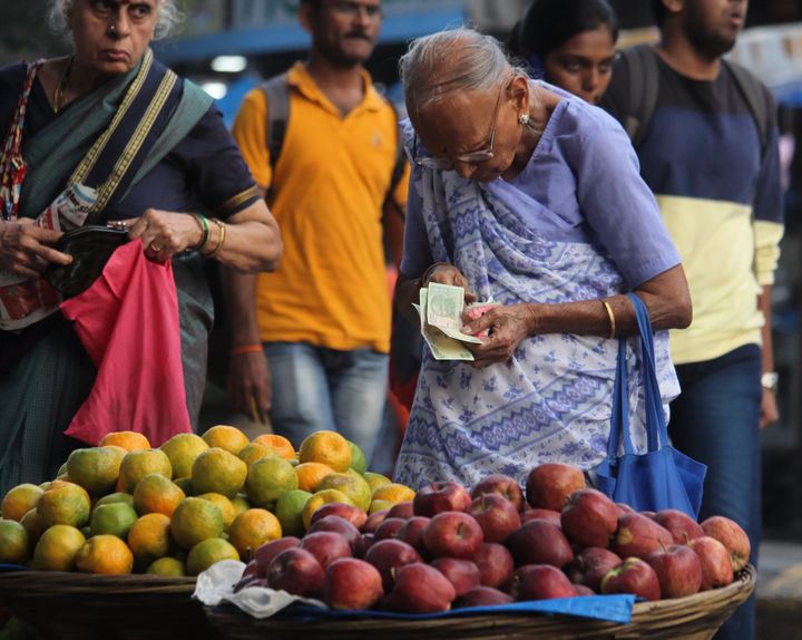 An old woman buys fruits from a roadside stall in Mumbai on 14 November 2019. 