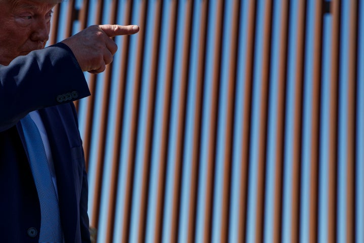 President Donald Trump talks with reporters as he tours a section of the southern border wall, Wednesday, Sept. 18, 2019, in
