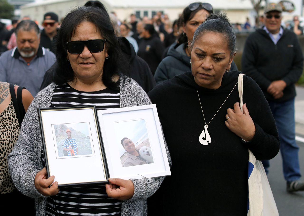 Relatives walk in the harbour as they wait for news of their missing loved ones 