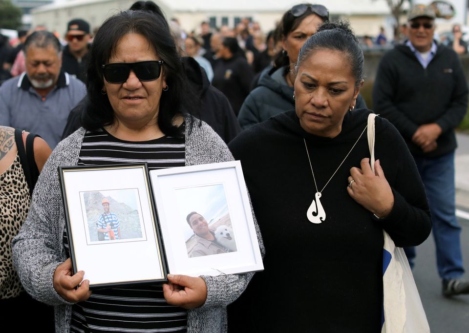 Relatives walk in the harbour as they wait for news of their missing loved ones 