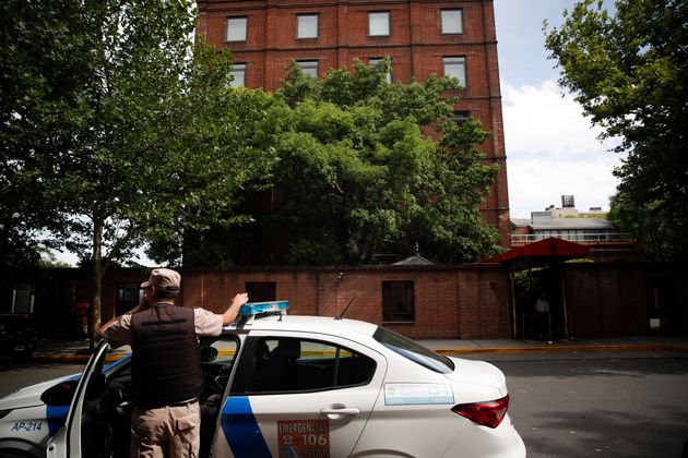 A police officer stands in front of the Faena Art Hotel in Buenos Aires, Argentina, hours after assailants trying to rob two British tourists shot and killed one of them and wounded the other, Saturday, Dec. 14, 2019 (AP Photo/Natacha Pisarenko)