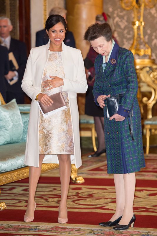 The Duchess of Sussex and Princess Anne attend a reception to mark the 50th anniversary of the investiture of the Prince of Wales at Buckingham Palace in London.