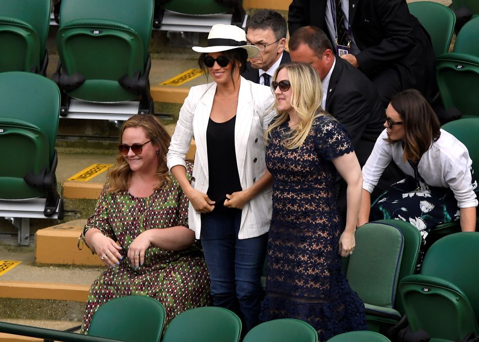 Meghan looks on as Serena Williams of the US wins her second-round match against Slovenia's Kaja Juvan at Wimbledon.