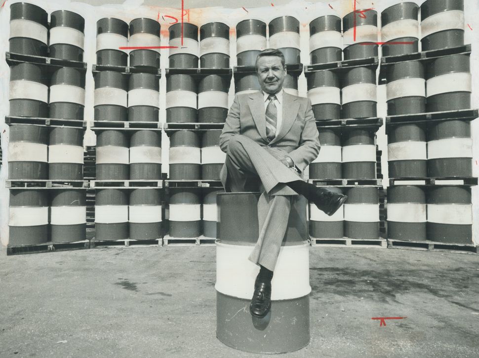 Every Canadian man, woman and child consumed on average each year the energy equivalent of these 49 barrels of crude oil pictured in 1977 with Imperial Oil's then-chairman John Armstrong. 