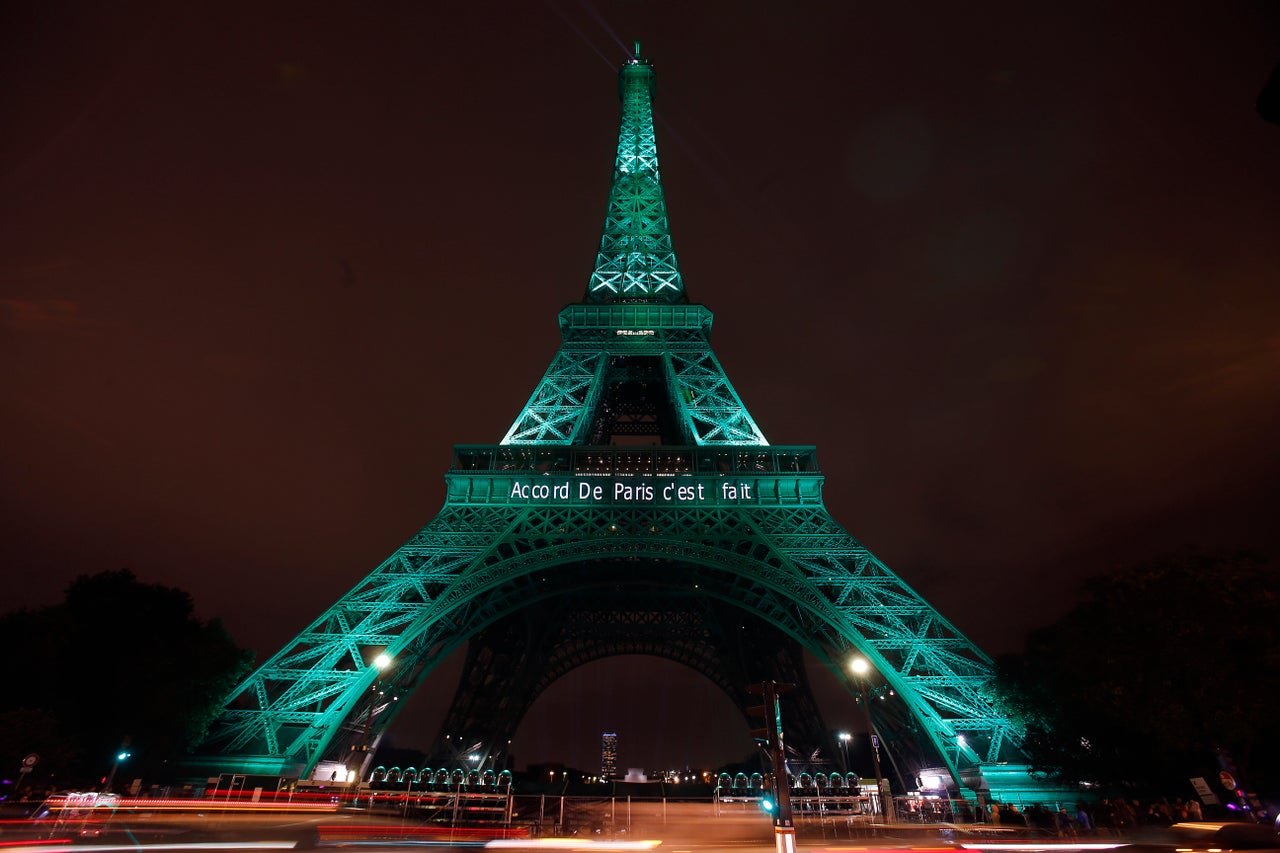 The Eiffel Tower is illuminated in green with the words "Paris Agreement is Done" on November 4, 2016.