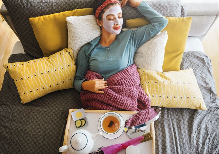 Young woman with a mask on her face is enjoying a morning weekend.