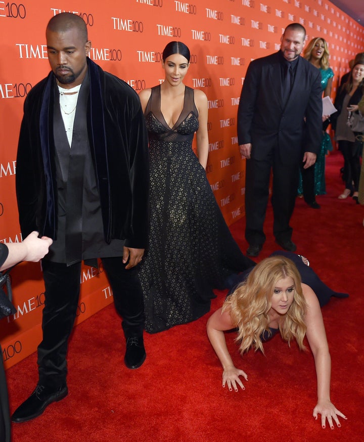 Schumer pretends to trip and fall on the floor in front of honorees Kim Kardashian and Kanye West as they attend the Time 100 Gala on April 21, 2015, in New York.