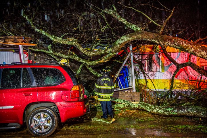Cory Simpson of Decatur Fire & Rescue assess damage before evacuating a mobile home after a tree fell on the home in Decatur, Ala., Monday, Dec. 16, 2019. (Dan Busey/The Decatur Daily via AP)